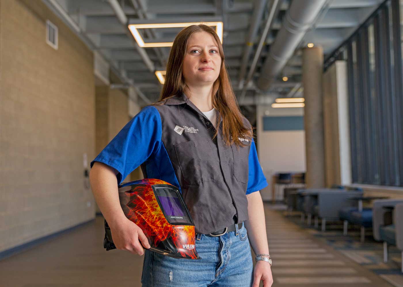 Image of woman holding welding mask