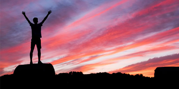 Person raising arms triumphantly.