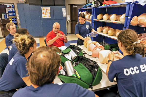 OCC instructor shown talking to EMS students.