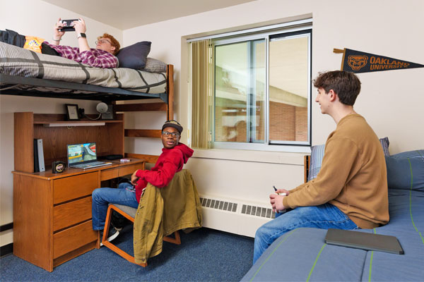 Three students sitting and talking in a residence