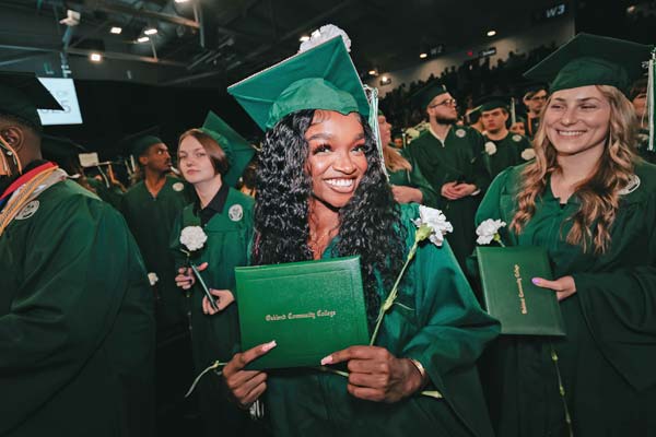 A 2025 OCC graduate showing diploma cover