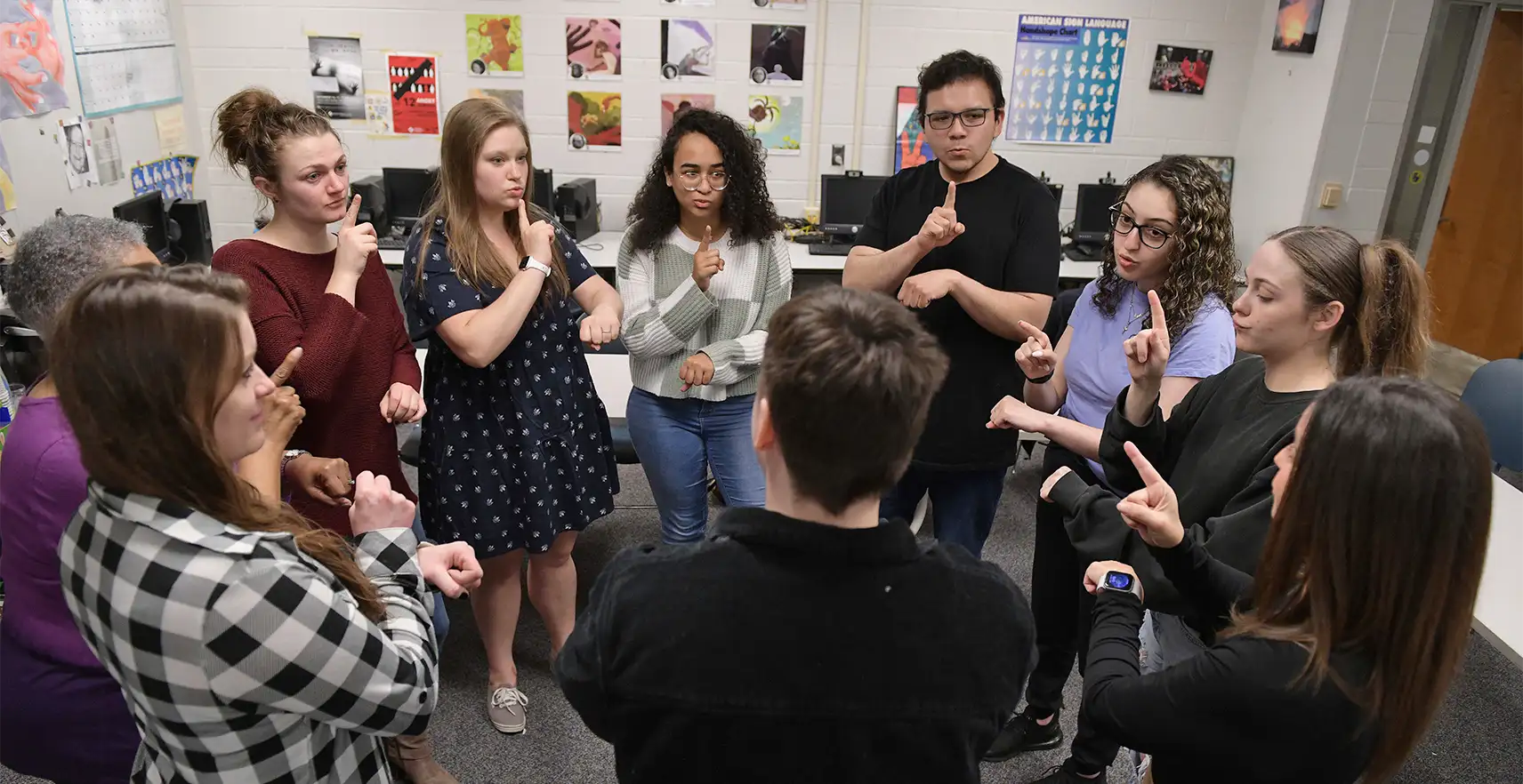 Photo of OCC Sign Language students practice communicating.  