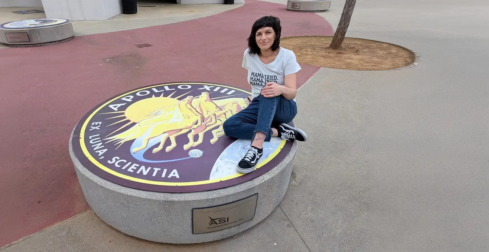 OCC student sitting on a NASA Apollo XIII display.