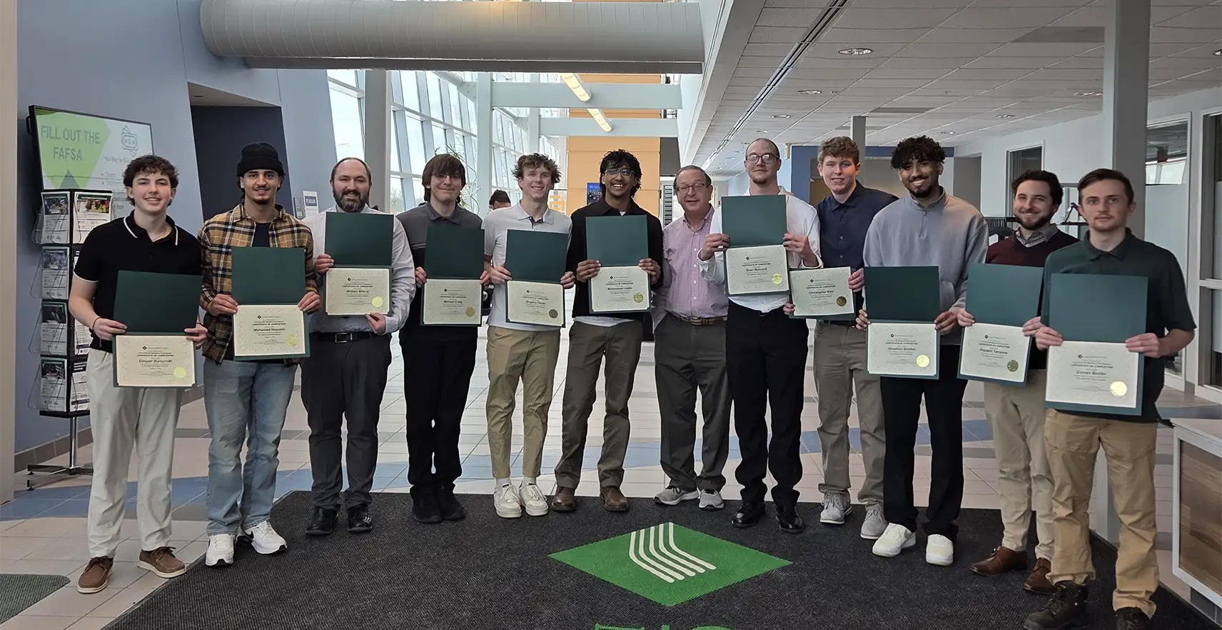 Group of students holding their Pre-Apprenticeship complettion certificates