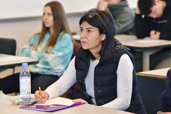 Woman sitting at a desk taking notes