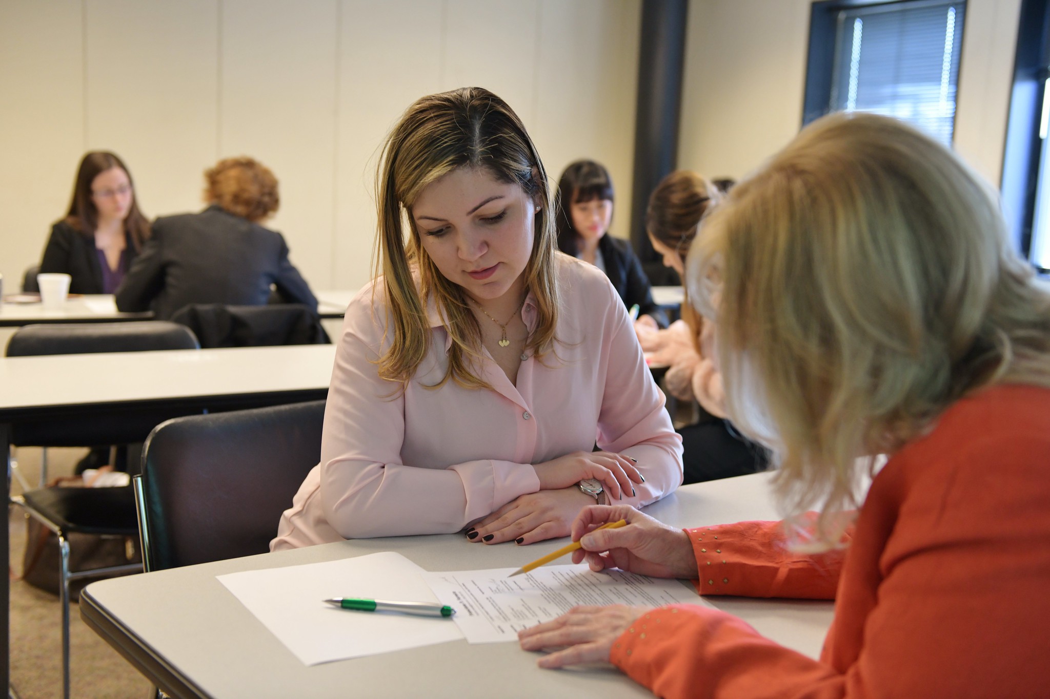 Two women sitting over a job application.
