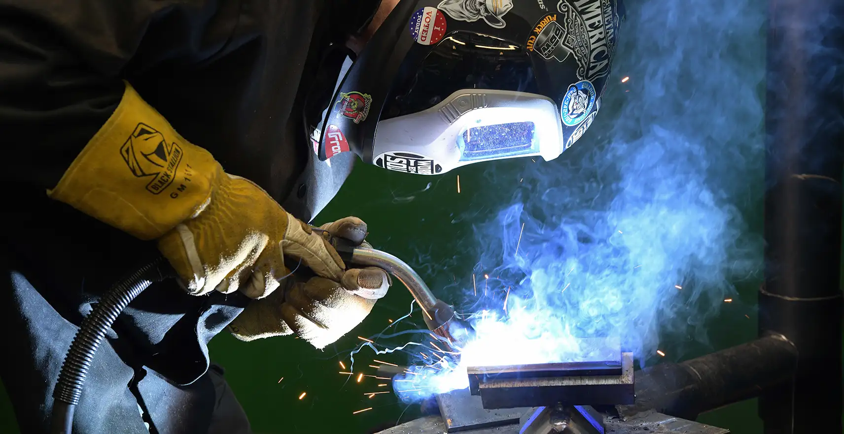 A welder using a welding torch