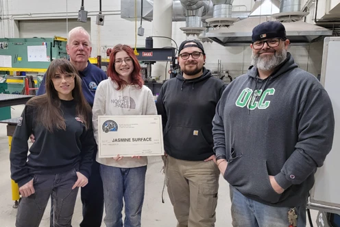 Roger Smith from the Antique Motorcycle Foundation (second from left) presents OCC student Jasmine Surface (center) with a scholarship for welding. Also pictured are Welding and Fabrication Technology staff and Cameron Berrier.