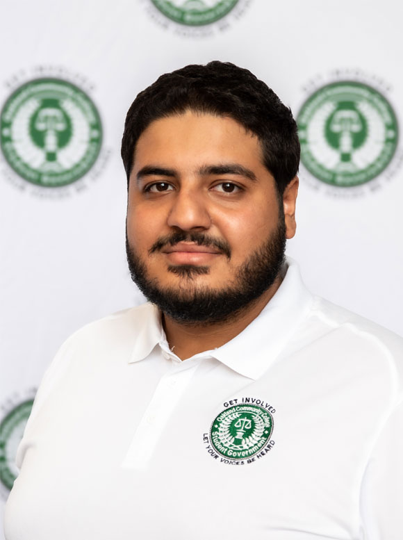 Hayder Alanbari Portrait of a man in a white polo shirt with a green logo