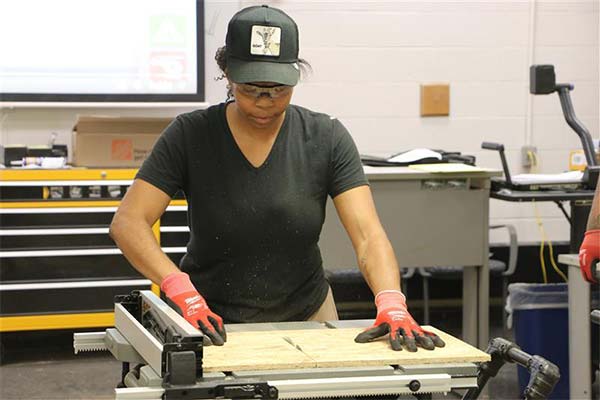 student using a saw
